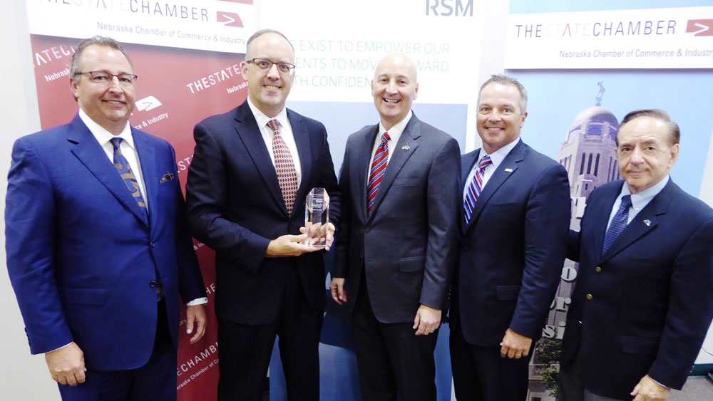 Ryan Parker Receiving the award from the Governor and Chamber